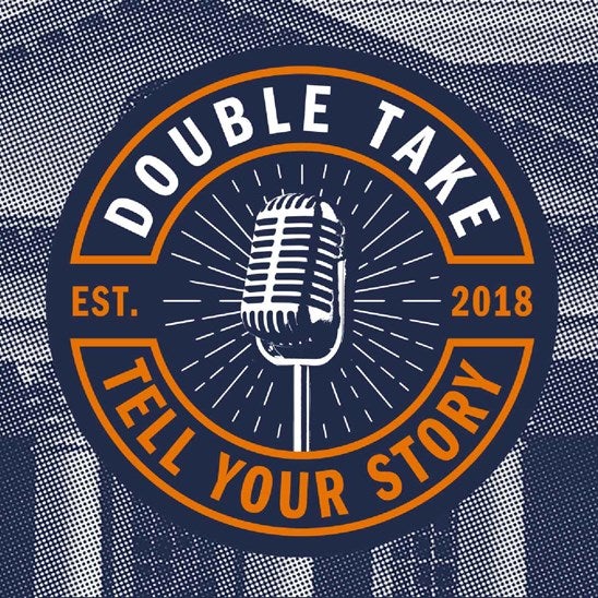 Logo with a microphone in the middle. Around the edge of the circle, it reads "Double Take" and "Tell Your Story" along with "Est. 2018"