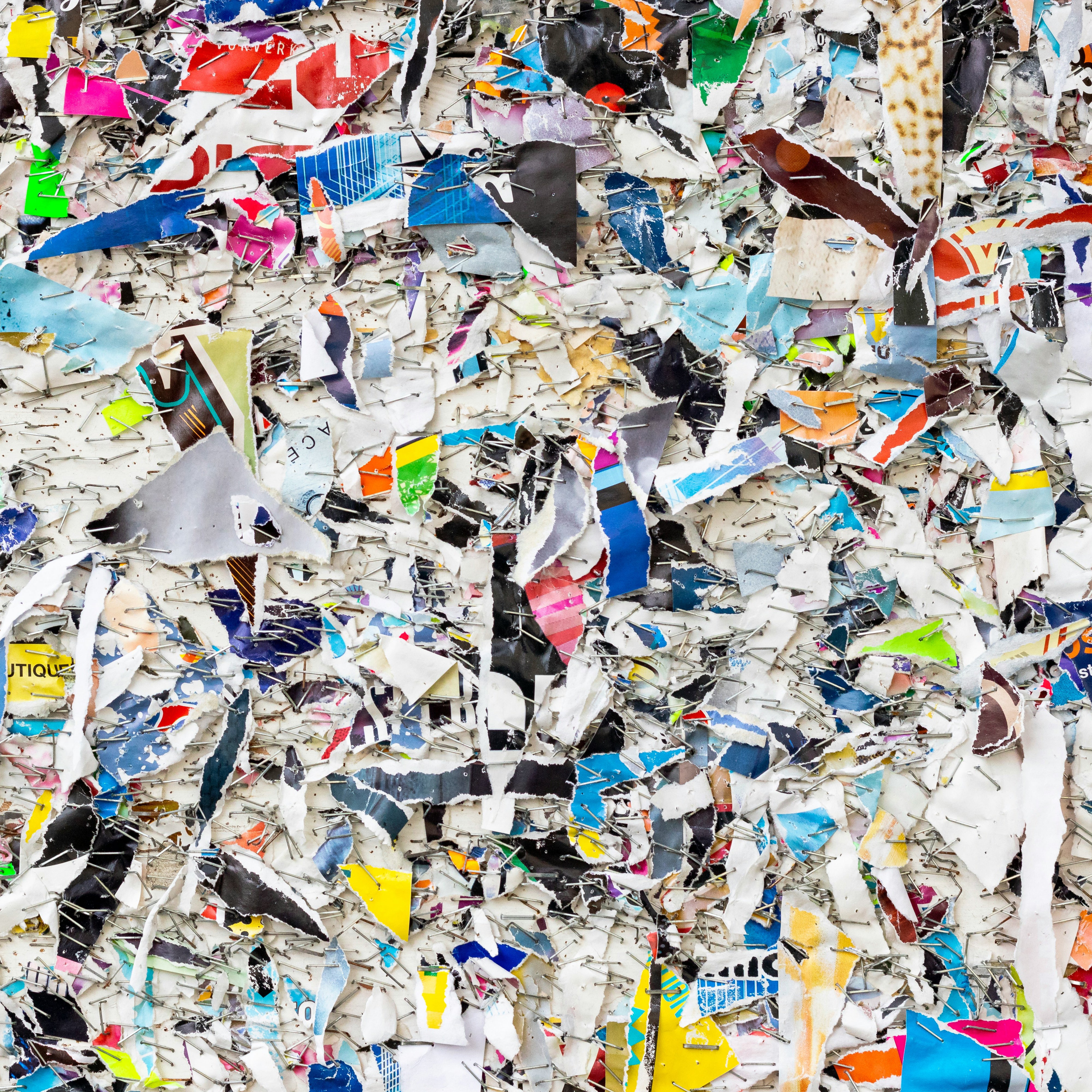 Layered paper remnants on a bulletin board