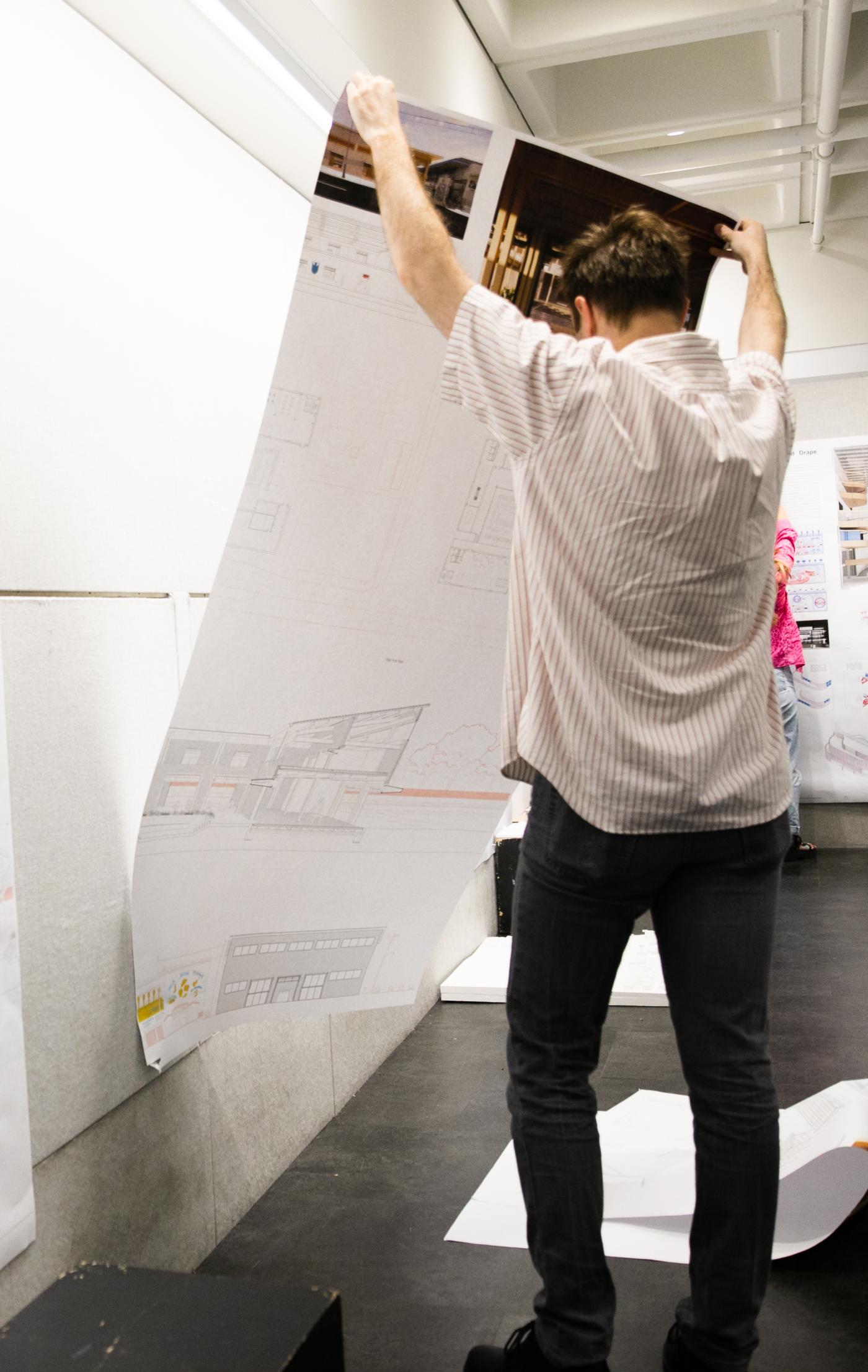 Student pinning up work at the A-School - Photo by Tom Daly 1