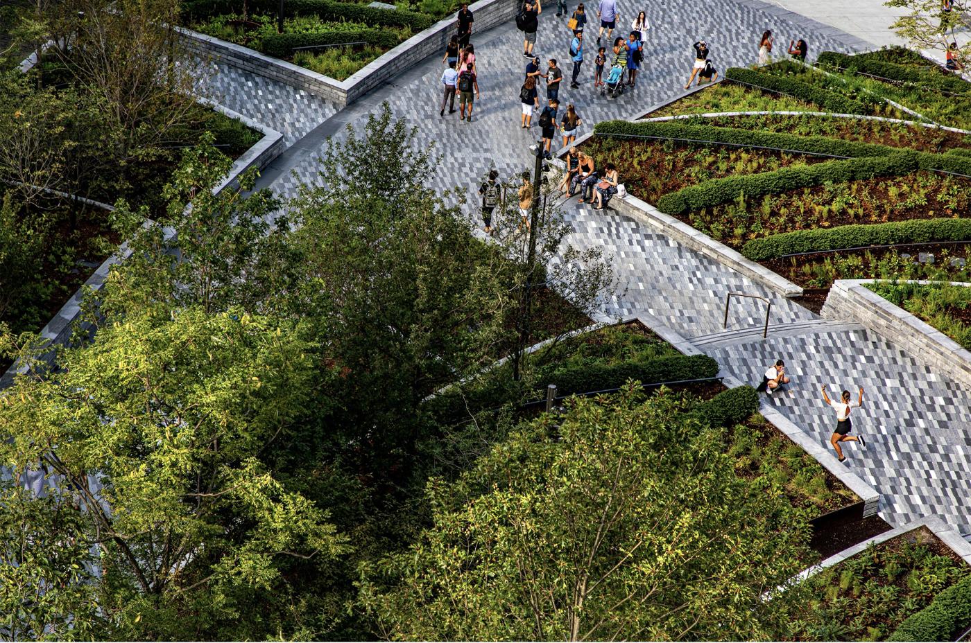 Overview image of Hudson Yards Plaza - people walking on large paths through urban forest