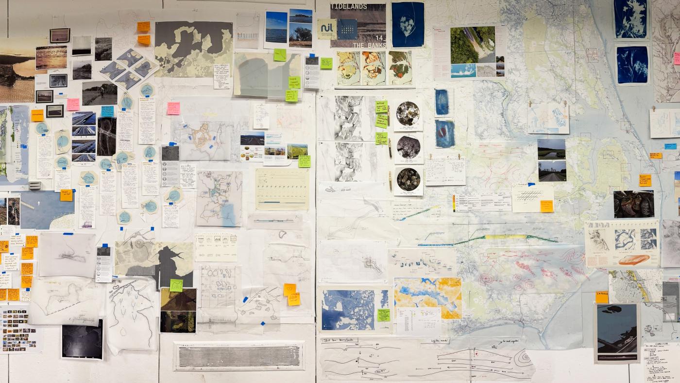 Photo of exhibition walls - collaged presentation of sketches, diagrams, maps, and more