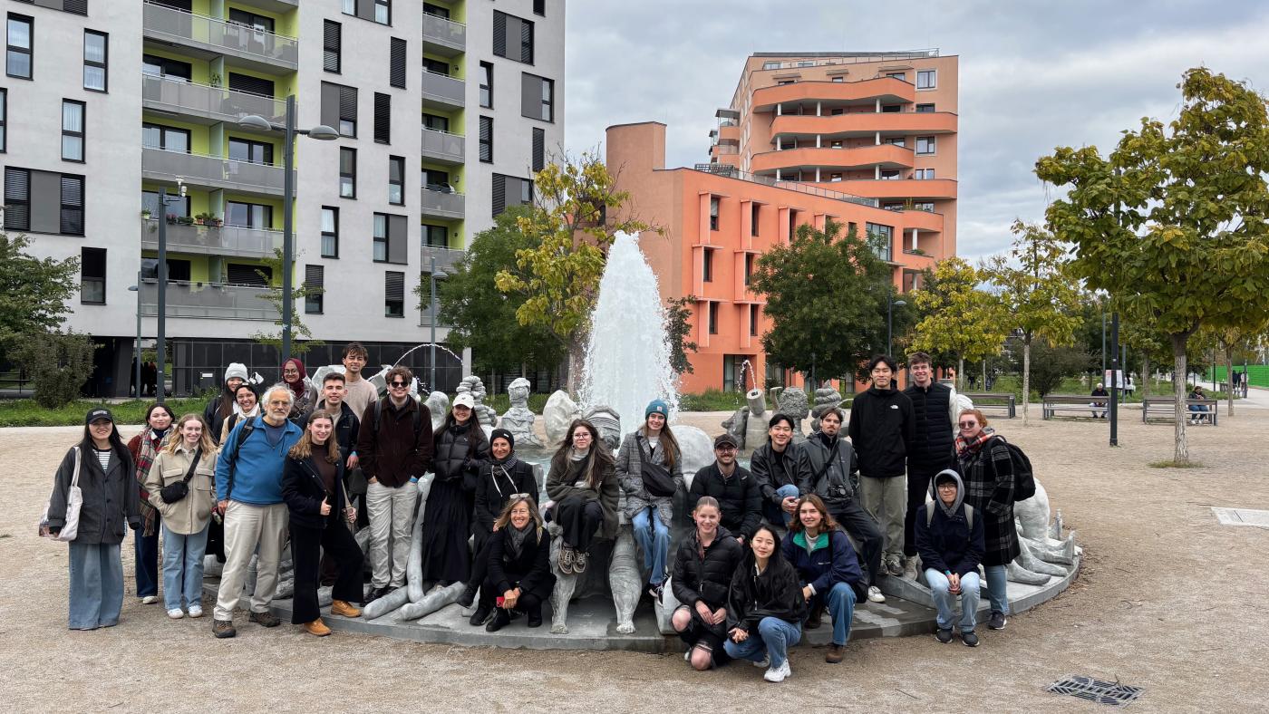 Student and faculty group in front of fountain in a plaza in Vienna