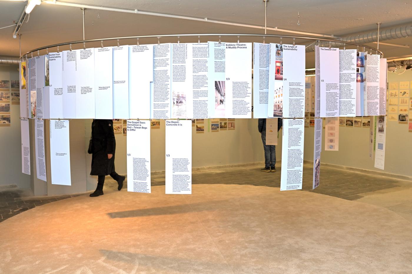 Room installation with hanging panels that have text on them